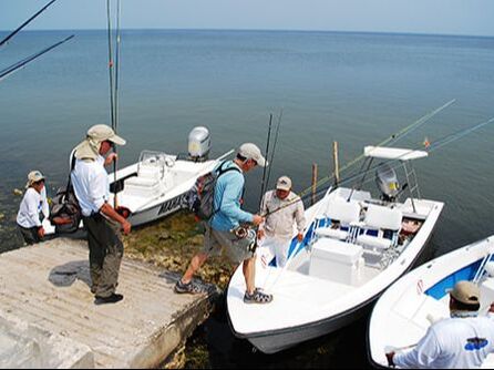 Fly fishing anglers getting in flats skiffs