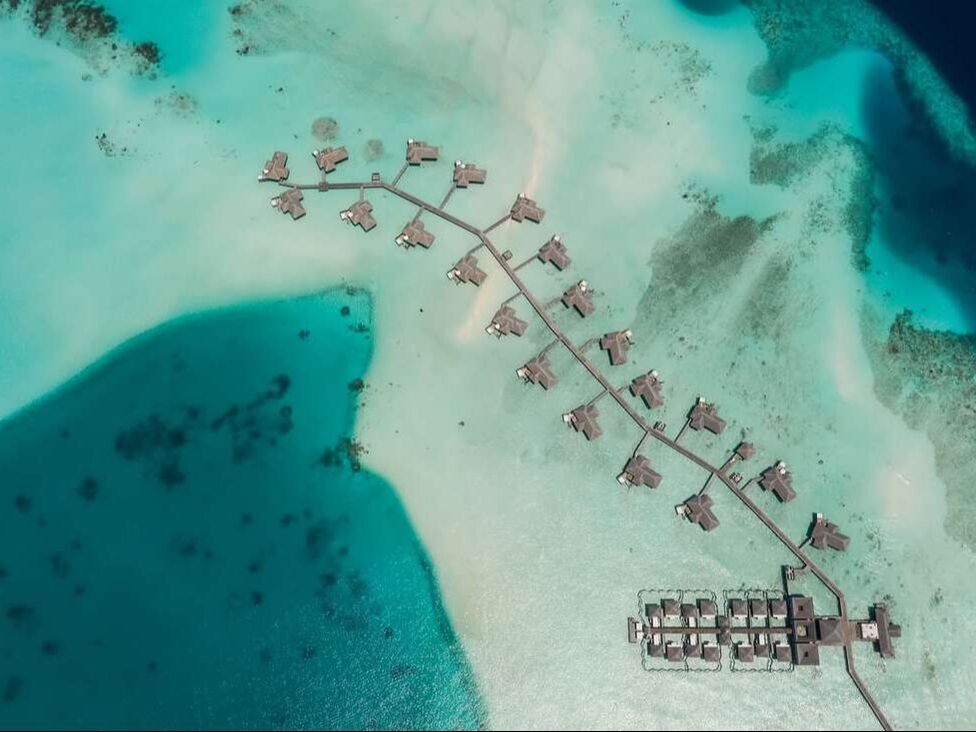 Conrad Maldives resort aerial view bungalows beach ocean