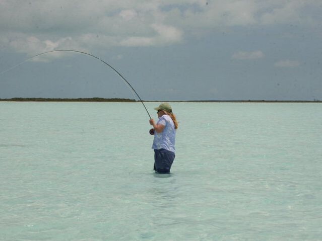 Kim wading fish on Bahamas
