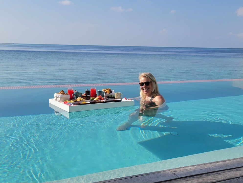 Kim with floating breakfast tray in private pool in Maldives
